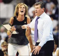  ?? Jessica Hill / Associated Press ?? UConn associate coach Chris Dailey, left, pulls back head coach Geno Auriemma during a 2013 game in Bridgeport.