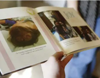  ?? KHAMPHA BOUAPHANH PHOTOS/FORT WORTH STAR-TELEGRAM/TNS ?? Kaitlynn Curtner goes through a photo book her mother made in the days following her brain surgery at her home.