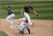  ?? JEFF CHIU — THE ASSOCIATED PRESS ?? Oakland Athletics shortstop Elvis Andrus, left, cannot field a throwing error by third baseman Matt Chapman, top, as the Houston Astros’ Myles Straw (3) advances to second base during the sixth inning in Oakland on Sunday.