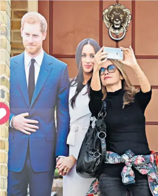  ??  ?? Popular: taking a selfie with cardboard cutouts of Harry and Meghan is a treat, but an Instagram link will be even better