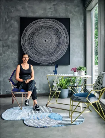  ??  ?? TOP OF HER GAME Rugs called Path Finder and tables christened the Split Personalit­y can be seen here along with designer Anica Kochhar