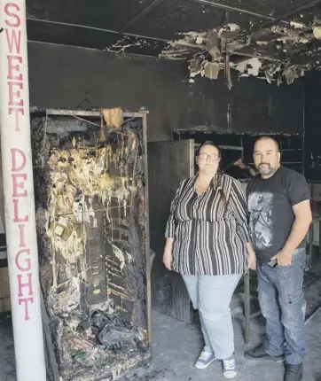  ??  ?? DAMAGE: James Barry and Natasha Parry vow to rebuild their fire-ravaged cafe, Sweet Delight @ The Mill Cafe, Shay Lane, Holmfield, Halifax