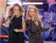  ?? AP FILE] [PHOTO BY WADE PAYNE, INVISION/ ?? Carrie Underwood, left, and Miranda Lambert perform at the 2014 CMT Music Awards.