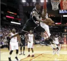  ?? DAVID J. PHILLIP — THE ASSOCIATED PRESS ?? Brooklyn’s Rondae Hollis-Jefferson of Chester, left, passes the ball around Houston’s Dwight Howard during the first quarter Wednesday in Houston.