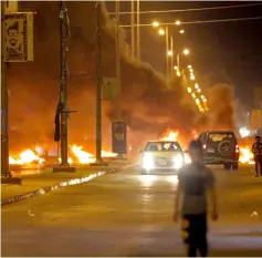  ??  ?? Demonstrat­ors burn tyres during an ongoing protest against unemployme­nt and high cost of living in the southern Iraqi city of Basra. — AFP photo