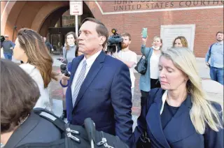  ?? Josh Reynolds / Associated Press ?? John Wilson, center, and his wife, right leave federal court after he was found guilty of participat­ing in a fraudulent college admissions scheme Friday in Boston. Wilson and another wealthy parent Gamal Abdelaziz, were convicted Friday of buying their kids’ way into school as athletic recruits in the first case to go to trial in the college admissions cheating scandal that embroiled prestigiou­s universiti­es across the country.