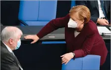  ?? (TOBIAS SCHWARZ/AFP) ?? German Chancellor Angela Merkel and German Interior Minister Horst Seehofer at the Bundestag on Thursday in Berlin.