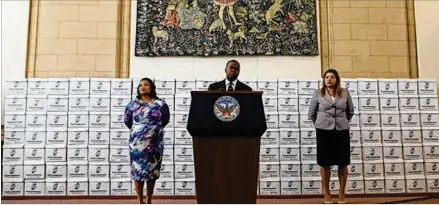  ?? HENRY TAYLOR/HENRY.TAYLOR@AJC.COM 2017 ?? Atlanta Mayor Kasim Reed stands in front of documents as he announces the release of records tied to the federal probe in February 2017. Last week, Reed said documents in a withheld subpoena from Sept. 9, 2016, were “unrelated” to the federal bribery...