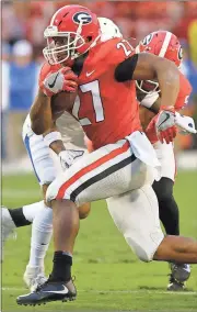  ?? Joshua L. Jones / Athens Banner-Herald via AP ?? Georgia tailback Nick Chubb (27) rushes for 151 yards Saturday to push him past 1,000 yards for the third time — joining Herschel Walker for the UGA record.
