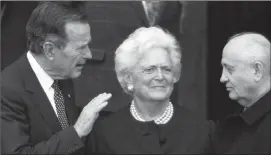  ??  ?? Former U.S. President George H.W. Bush, left, chats with former Soviet leader Mikhail Gorbachev, right, as Barbara Bush looks onin this 1999 Associated Press file photo.