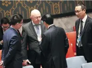  ?? DREW ANGERER / GETTY IMAGES ?? Vasily Nebenzya, second from left, Russian ambassador to the UN, speaks with Wu Haitao, Chinese deputy ambassador to the UN, in New York City on Thursday.