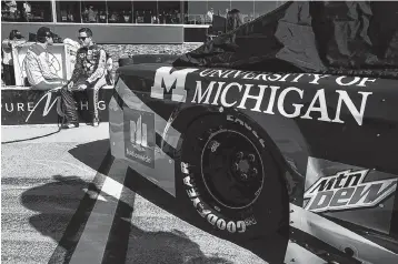  ??  ?? Alex Bowman, right rear, talks with Ryan Blaney along pit lane before Friday’s qualifying for Sunday’s NASCAR Sprint Cup Series Pure Michigan 400 at Michigan Internatio­nal Speedway, in Brooklyn, Mich.