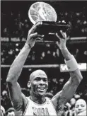  ?? ED WAGNER/CHICAGO TRIBUNE ?? Michael Jordan hoists the All-Star MVP trophy at Chicago Stadium in 1988.