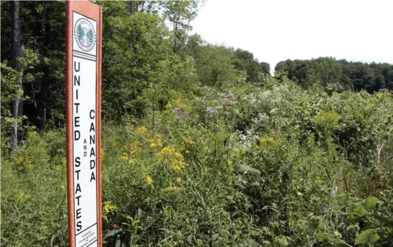  ?? aP FIle ?? NORTH OF THE BORDER: A marker in Richford, Vt., indicates the official border between the United States and Canada. Five Mexican citizens were apprehende­d Tuesday after entering the U.S. in remote northern Maine.