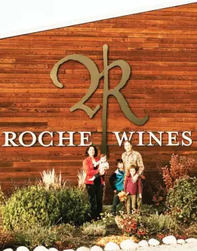  ?? Special to The Okanagan Weekend ?? Penelope and Dylan Roche outside their namesake winery on the Naramata Bench with their three children.