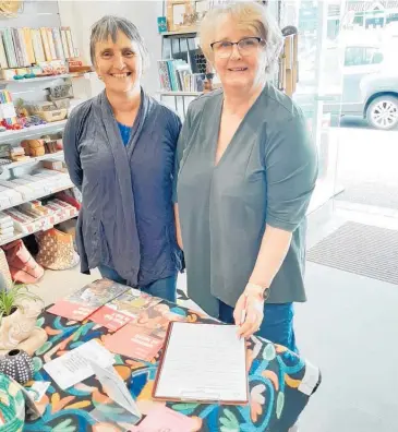  ??  ?? Napier Trade Aid assistant manager Evelyn Henson (left) and manager Maureen Kennedy encourage shoppers to sign the anti slavery petition.