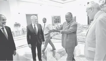  ??  ?? Djibouti President Ismail Omar Guelleh (second right) welcomes Mattis (second left) at the Presidenti­al Palace in Djibouti. — Reuters photo