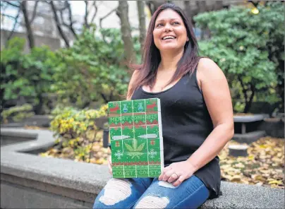  ?? CP PHOTO ?? Lorilee Fedler, owner of Coast to Coast Medicinals, is pictured with her cannabis Christmas calendars in Vancouver, B.C., on Saturday. A Vancouver cannabis company is scrambling to keep up with a flood of orders for marijuana-filled advent calendars,...