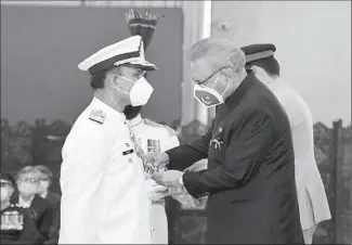  ??  ?? ISLAMABAD President Dr. Arif Alvi conferring Nishan-e-Imtiaz (military) on Chief of the Naval Staff, Admiral Muhammad Amjad Khan Niazi, at a special investitur­e ceremony held, at Aiwan-e-Sadr.