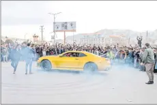  ?? ?? A driver performs a stunt with a modified car in a street during a car racing competitio­n in Kabul.