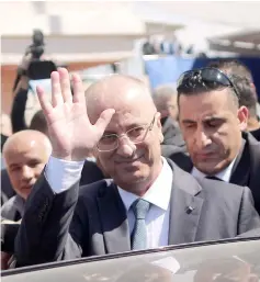  ?? — AFP photo ?? Hamdallah waves to the crowd upon his arrival in Gaza City.