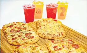  ?? CHRIS YOUNG THE CANADIAN PRESS ?? Tim Hortons is launching its new flatbread pizza pilot nationally this week with, clockwise from top left: bacon everything, cheese, pepperoni and chicken Parmesan.