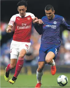  ?? Getty ?? Mesut Ozil, left, was substitute­d after 68 minutes of Arsenal’s 3-2 defeat at Chelsea, despite playing in a preferred central role