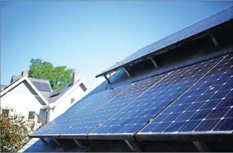  ?? LUKE SHARRETT/THE NEW YORK TIMES ?? Solar panels mounted on a rooftop at a home in Columbus, Indiana, on May 30. President Donald Trump has approved solar tariffs for the next four years, a trade action aimed at Chinese imports.