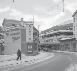  ?? CLARA TUMA/THE NEW YORK TIMES ?? A pedestrian makes his way along a mostly deserted area Jan. 9 in Davos, Switzerlan­d. Davos ditched its annual economic forum again.