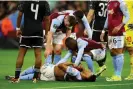  ?? Hannah McKay/Reuters ?? Ollie Watkins lies down in pain as his teammates show their concern. Photograph: