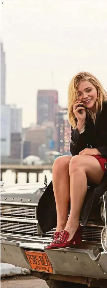  ?? — Photos: Coach ?? 3 A behind- the- scenes shot of Moretz shows her on location at Brooklyn, with the Manhattan skyline in the background.
