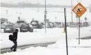  ??  ?? A traveler makes his way to a shuttle stop after a snowstorm at Denver internatio­nal airport. Photograph: Bob Strong/Reuters