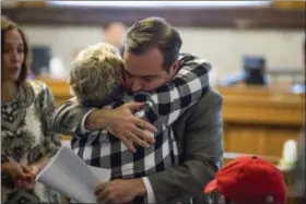  ?? MEG VOGEL — THE CINCINNATI ENQUIRER VIA AP ?? Cincinnati Mayor John Cranley hugs a member of Kyle Plush’s family before council’s Law and Public Safety Committee meeting where Kyle Plush’s death after he accidental­ly got pinned in the fold-away back seat of a minivan was discussed inside the Council Chambers at City Hall in Cincinnati. The teen’s April 10 death has triggered long-overdue plans for upgrades at the city emergency center and helped force the city manager’s resignatio­n, and more changes could come after the Cincinnati police department’s internal probe, the county prosecutor’s investigat­ion and vehicle safety reviews.