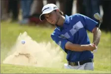  ?? DAVE THOMPSON, THE ASSOCIATED PRESS ?? Canada’s Austin Connelly chips out of the bunker on the first hole. He finished tied for 14th at 2 under.