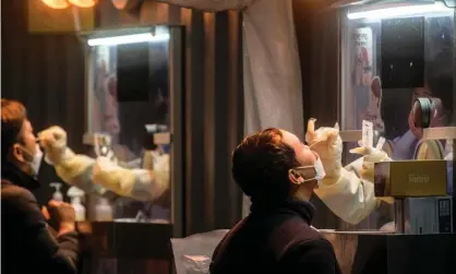  ?? Photograph: Anthony Wallace/AFP/Getty Images ?? Health workers carry out PCR tests at a Covid testing centre in Seoul.