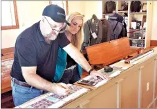  ?? COURTESY PHOTO ?? Workers Scott and Jamie McGowen from Scott Frame and Art in Rogers measure veterans’ photos before placing them on the walls of the McDonald County Historical Society Museum. The Stories of Military Service exhibit, which features 113 framed photos on...