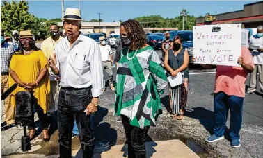  ?? PHOTOS BY ALYSSA POINTER / ALYSSA.POINTER@AJC.COM ?? U.S. Democratic Congressma­n Hank Johnson and DeKalb County Commission­er Mereda Davis Johnson speak during a news conference Tuesday at a south DeKalb County post office. Johnson said President Donald Trump “is engaged in a conspiracy to deprive Americans of their right to a full and free election.”