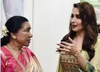  ?? Agence France-presse ?? Asha Bhosle (left) and actress Madhuri Dixit Nene talk during a promotiona­l event for a mobile phone in Mumbai on Friday.