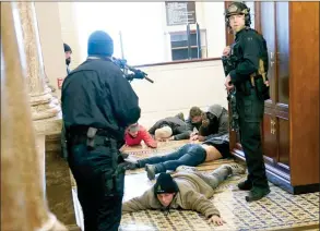  ?? The Canadian Press ?? U.S. Capitol Police hold protesters at gun-point near the House Chamber inside the U.S. Capitol on Wednesday, in Washington.