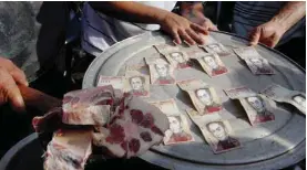  ??  ?? SAN CRISTOBAL: People protest on the “Troncal 5” road over the lack of cash as the new bank notes have not appeared, in San Cristobal, in Venezuela’s Tachira state yesterday. — AFP