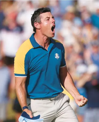  ?? RICHARD HEATHCOTE/GETTY ?? Rory McIlroy celebrates after winning in singles Sunday to help Europe beat the U.S. at the Ryder Cup.