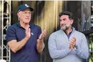  ?? Charles Rex Arbogast/Associated Press ?? LIV Golf CEO Greg Norman, left, and Yasir Al-Rumayyan, Governor of Public Investment Fund of Saudi Arabia, applaud the winners of the LIV Golf Invitation­al-Chicago tournament in September.