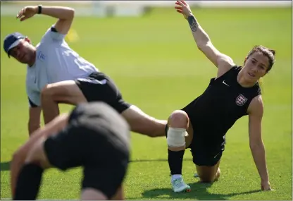  ?? ?? Lucy Bronze during England’s training session yesterday, watched from afar by Sarina Wiegman