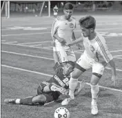  ?? Katharine Lotze/ The Signal ?? College of the Canyons midfielder Brian Cano battles Oxnard College defender Jerry Orozco for control of the ball as Daniel Aguilar looks on during a game at COC on Tuesday.