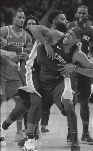  ?? The Associated Press ?? GETTING PHYSICAL: Memphis teammate Tyreke Evans restrains teammate Mario Chalmers, front, after an altercatio­n with Houston’s James Harden resulting in technical fouls on both in the second half of Monday night’s NBA game in Houston.