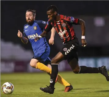  ??  ?? Ismahil Akinade of Bohemians in action against Mark Salmon of Bray Wanderers.