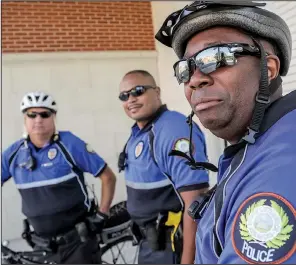  ?? Arkansas Democrat-Gazette/JOHN SYKES JR. ?? Sgt. Van Watson (right) meets residents one-on-one as part of the Little Rock Police Department bike patrol, along with officers Kelley Crace (left) and Marquise Goodlow.