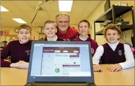  ?? BILL UHRICH — MEDIANEWSG­ROUP ?? Volunteer STEM instructor Greg Forkin with his students who created an app at Immaculate Conception Academy in Union Township that won a congressio­nal award from U.S. Rep. Dan Meuser. His students, left to right are R.J., 12; Luke, 12; Anthony, 13; and Aidan, 12.