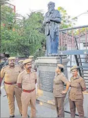  ?? PTI PHOTO ?? ▪ Police personnel guard a statue of Periyar in Coimbatore on Wednesday. A revered figure in Tamil Nadu politics, Periyar, born Venkata Ramasamy, fought against the caste system.