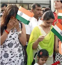  ??  ?? MYRIAD EMOTIONS: Some expats couldn’t hold back tears as they listened to patriotic songs at the Indian Consulate.